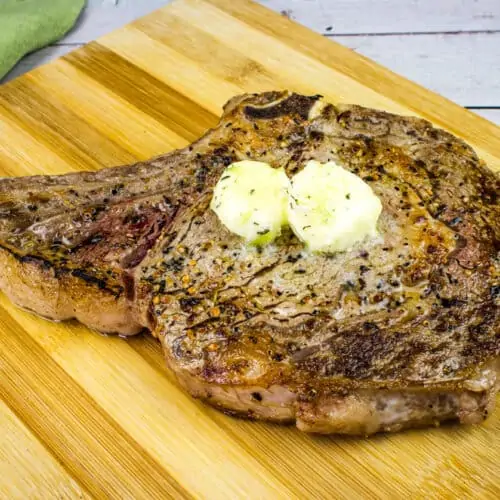Steaks on the Blackstone Griddle served on a chopping board.