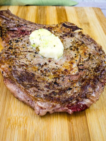 steak on a blackstone griddle cooked with butter on top