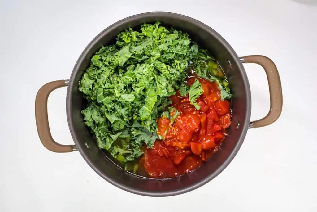 add kale, tomatoes, and broth to the pot