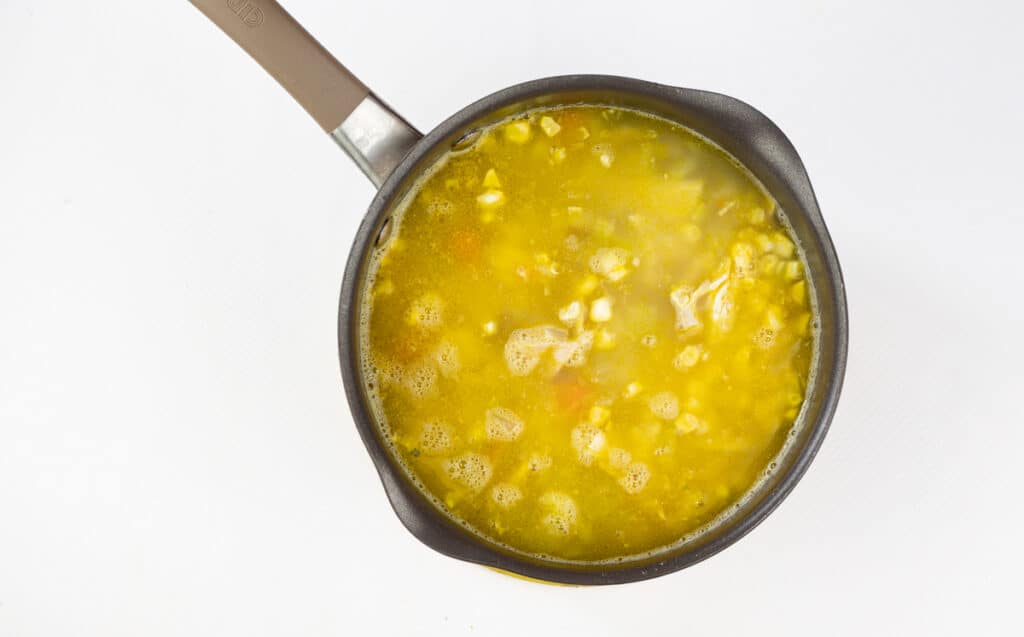 add chicken and corn and continue to simmer.