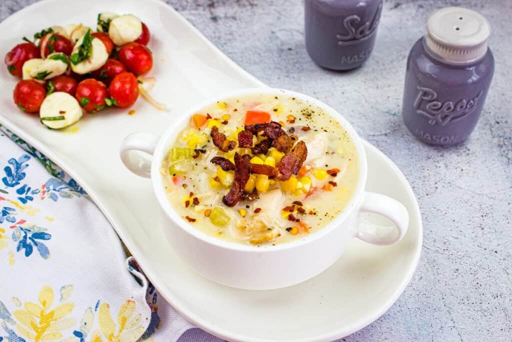 corn and chicken chowder in a white bowl