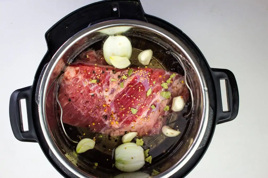 Add corned beef and aromatics to the instant pot