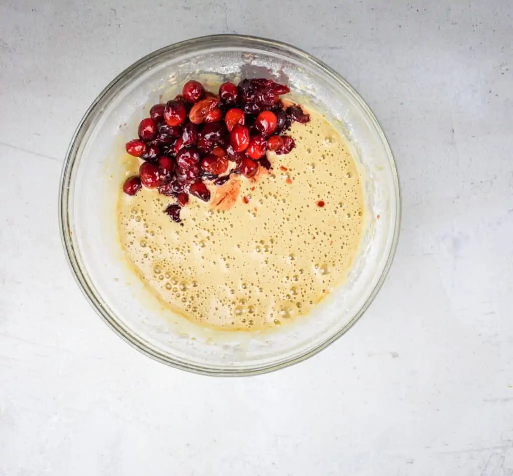 adding cooled cranberries to the egg mixture