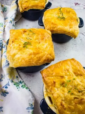 turkey pot pies with puff pastry in individual sized dishes.