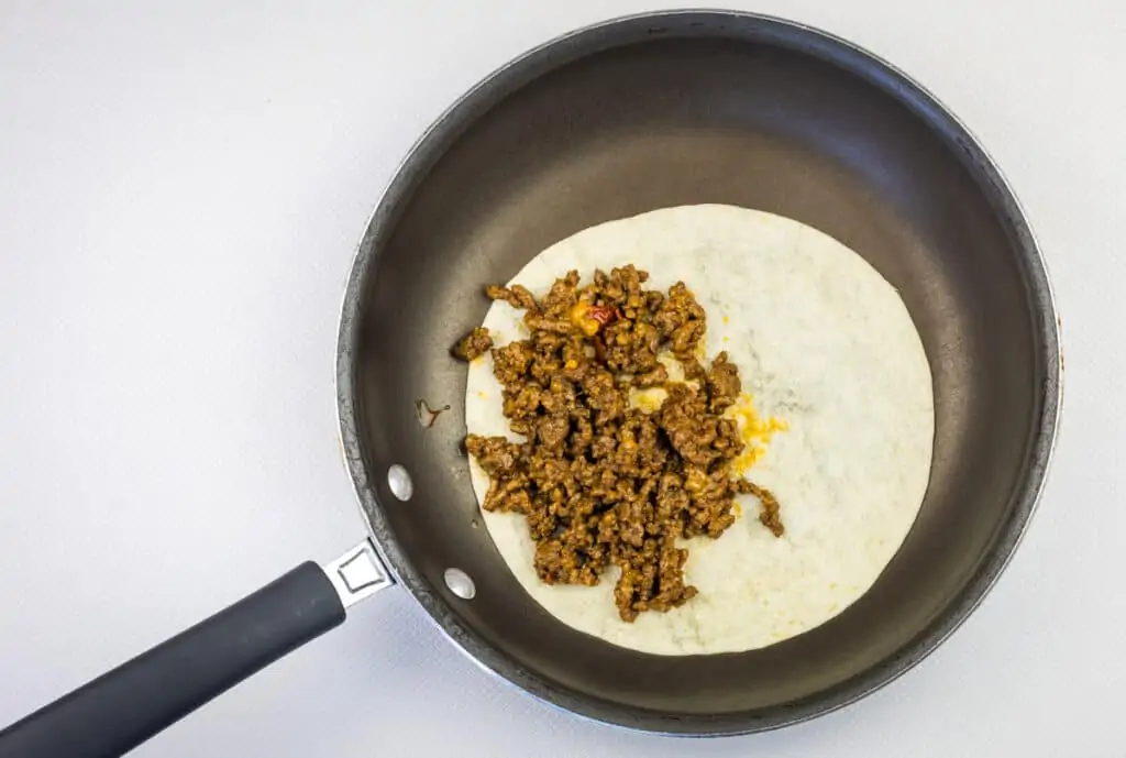 adding filling to half the tortilla