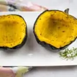 maple roasted acorn squash on a plate