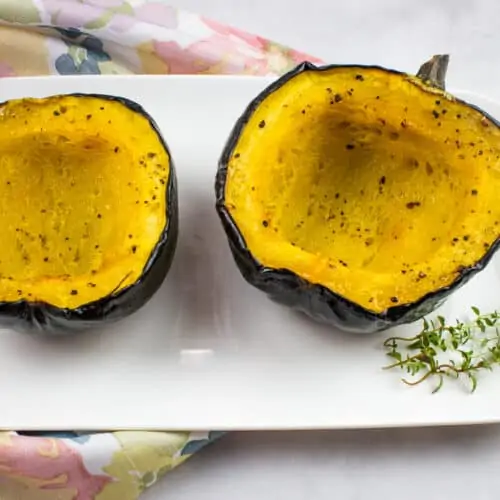 Maple roasted acorn squash on a plate.