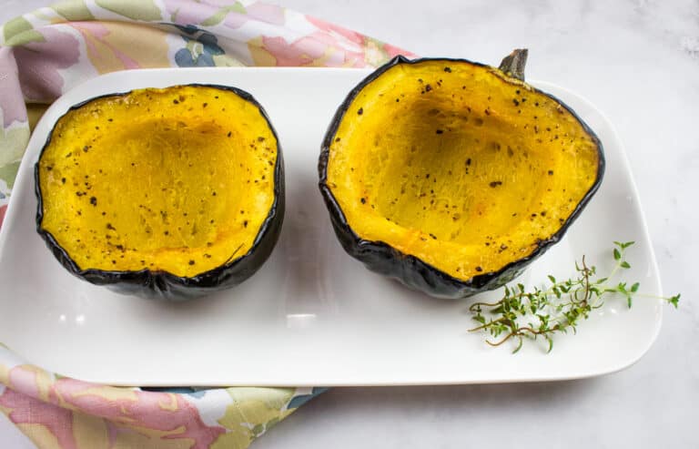 Maple roasted acorn squash on a plate.
