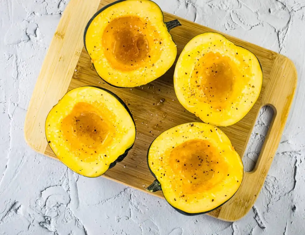 maple roasted acorn squash drizzled with oil, syrup, and salt and pepper