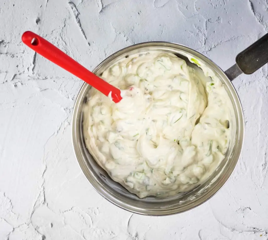 mixing in the soup, celery and onion to make cold crab dip