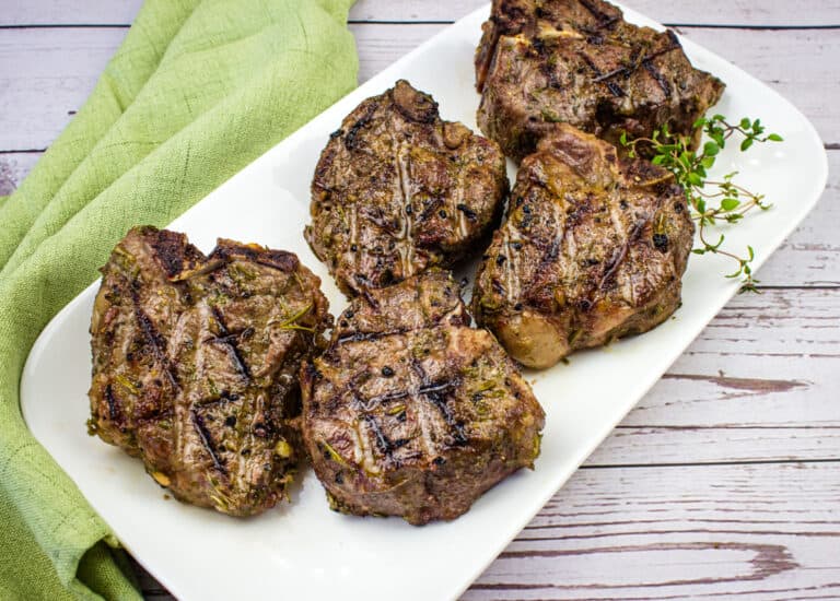 Smoked lamb chops on a plate.