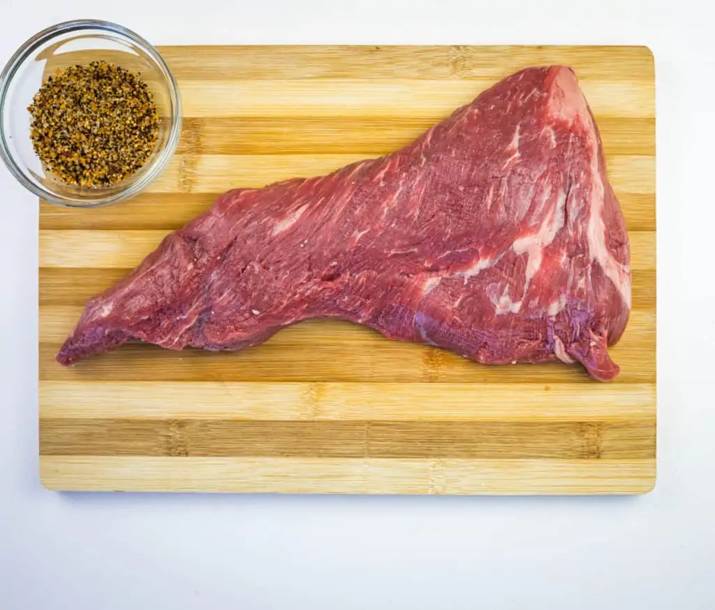 raw tri tip on a cutting board