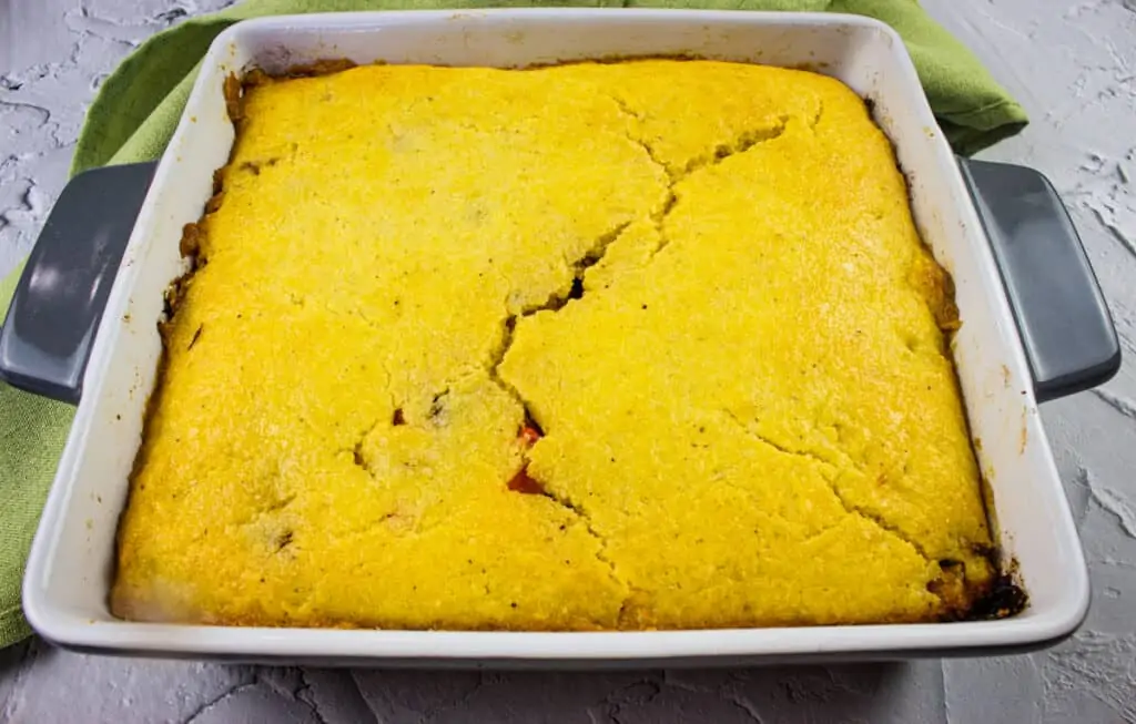 Baked stuffed cornbread in a baking dish.