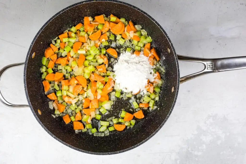 adding flour to veg mixture