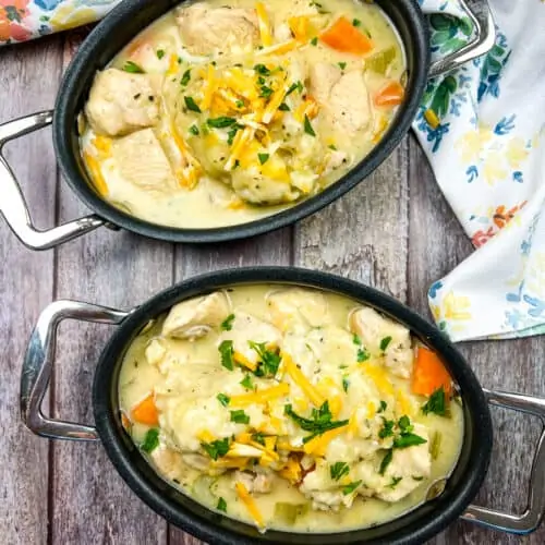chicken and cheddar dumplings in black serving dishes
