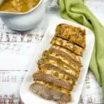 german pork loin slow cooker with gravy in the background