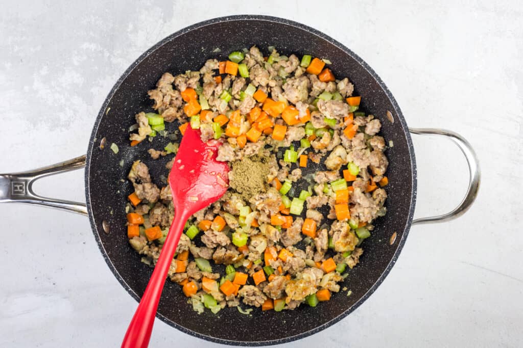 sauteeing the sausage and veg in a skillet