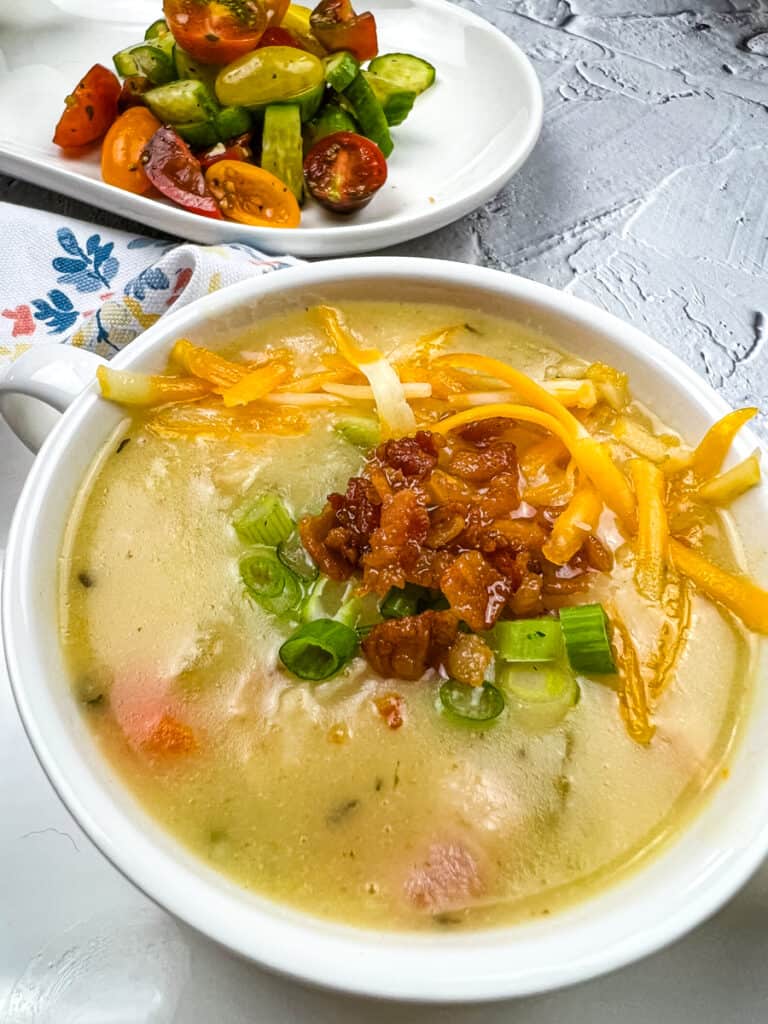 fully loaded baked potato soup in a white bowl