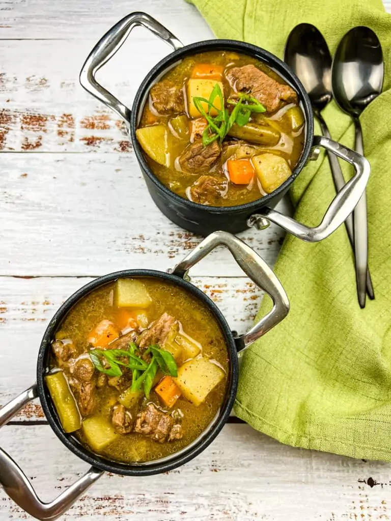 Steak and potato soup in two bowls.