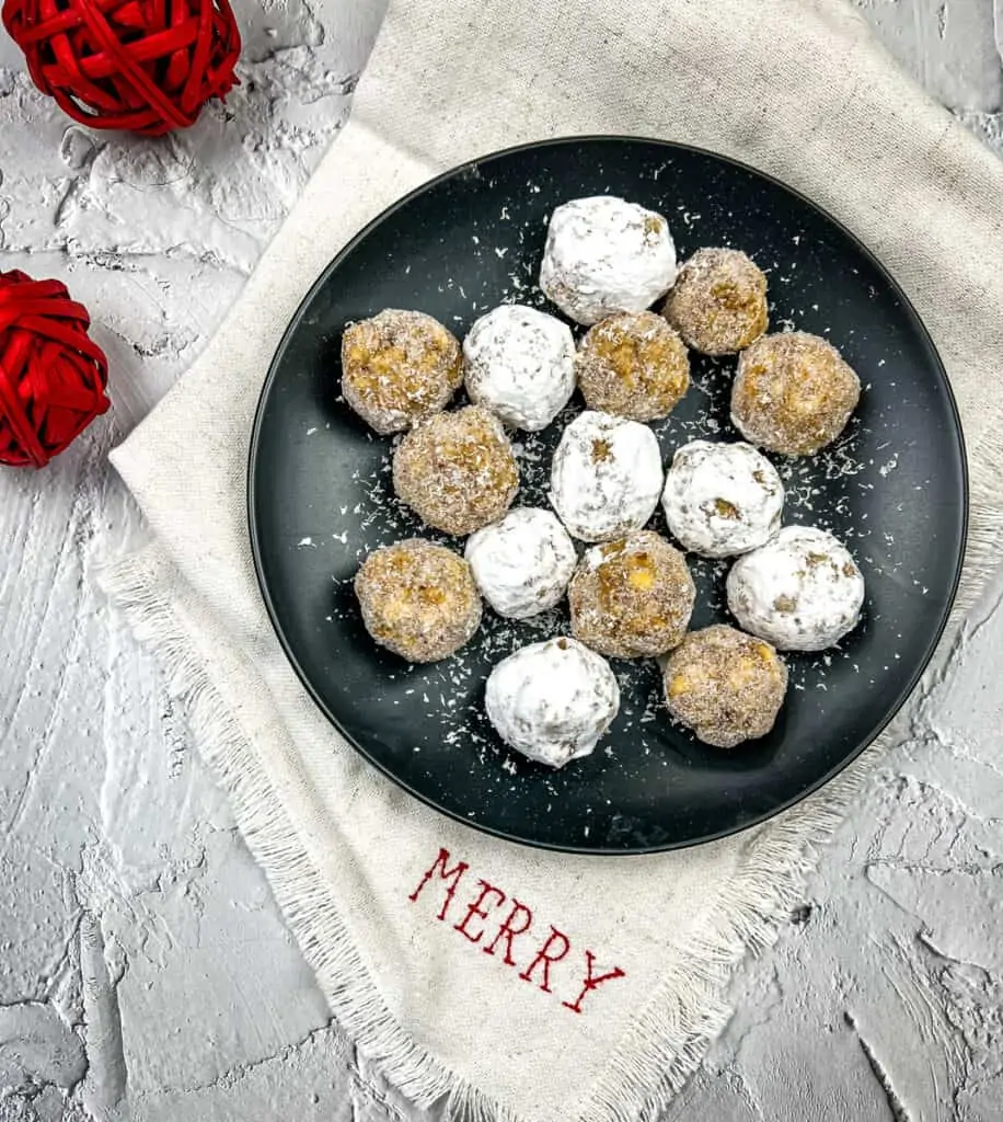 bourbon balls with white chocolate on a black plate