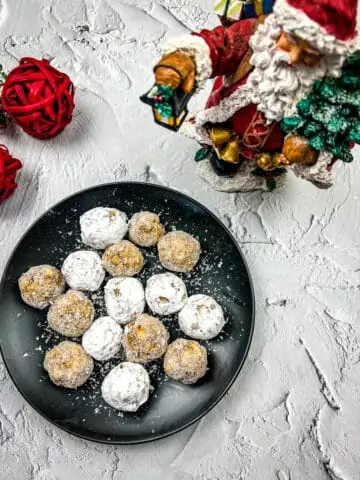 bourbon balls with white chocolate on a black plate