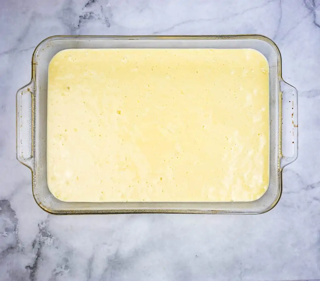 Eggnog Tres Leches cake batter in a 9 x 13 baking dish.