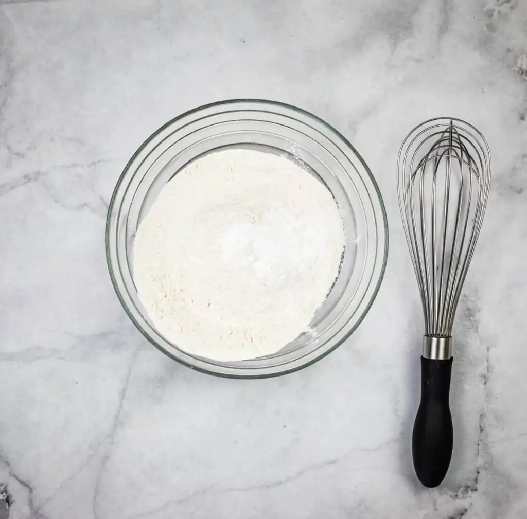 Flour, salt, and baking powder in a bowl.