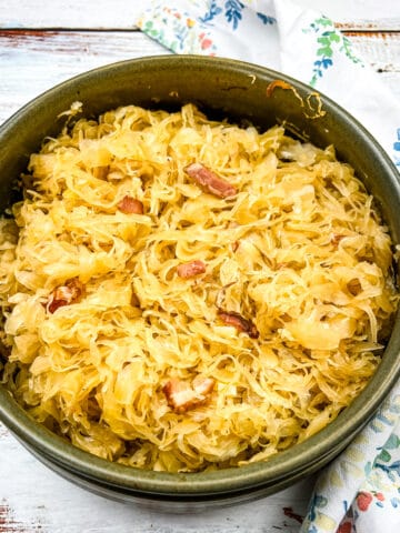 sauerkraut with apples and bacon in a casserole dish