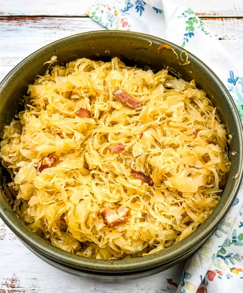 Sauerkraut in a serving dish with a spoon.