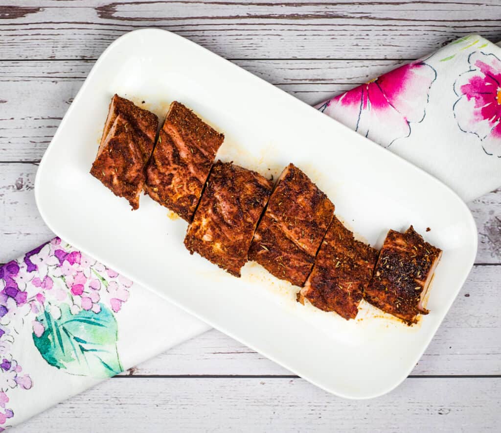 Smoked Pork Tenderloin sliced on a white serving platter.
