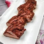 smoked pork tenderloin on a white plate