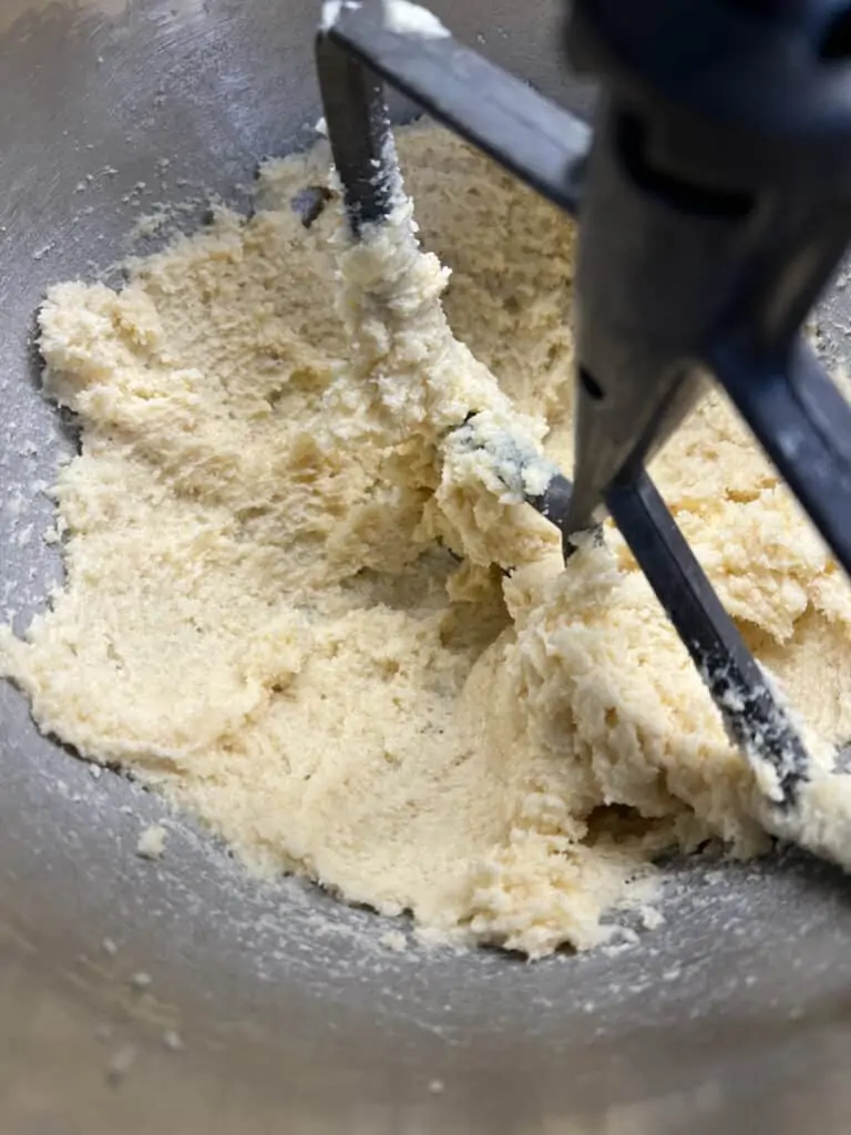 whipping the butter and sugar to make eggnog cookies with spiced rum glaze