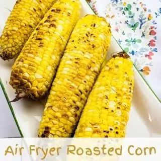 4 cobs of air fryer roasted corn on a plate.