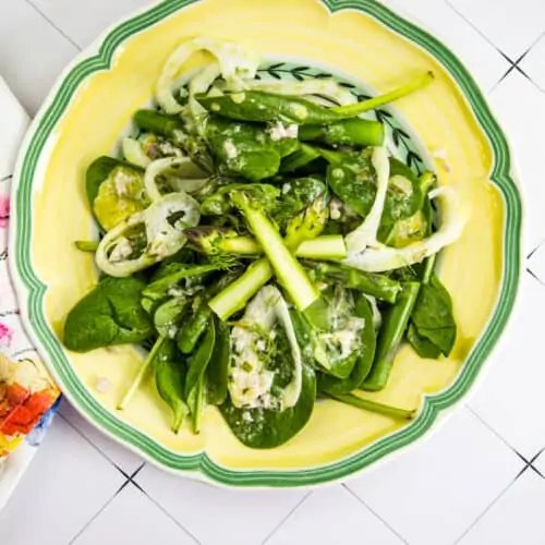 spinach, asparagus, & fennel salad on a yellow plate