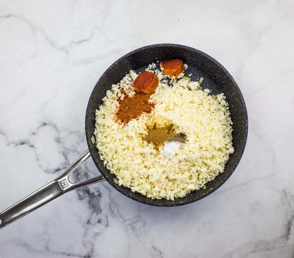 Add remaining ingredients to skillet to make vegan Mexican cauliflower rice