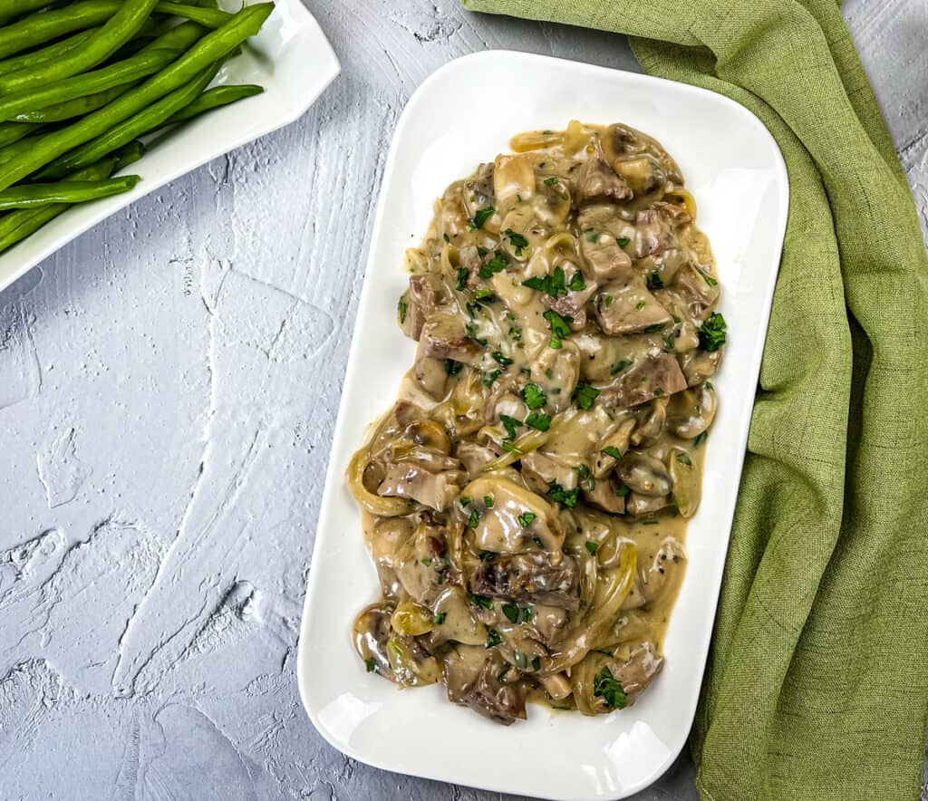 Leftover roast beef stroganoff on a white serving dish