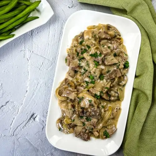 Leftover roast beef casserole on a white serving dish