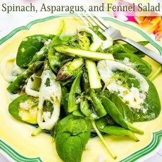 Spinach, asparagus, and fennel salad on a yellow plate.