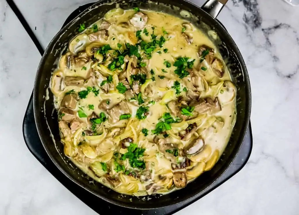 Sour cream and herbs have been added to the skillet with the leftover roast beef stroganoff.