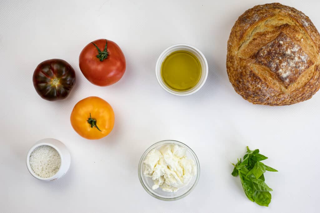 Ingredients to make grilled bread with tomatoes and ricotta