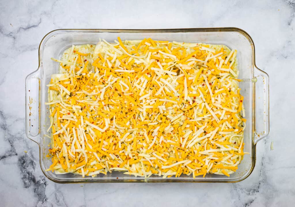 The casserole dish topped with cheese.