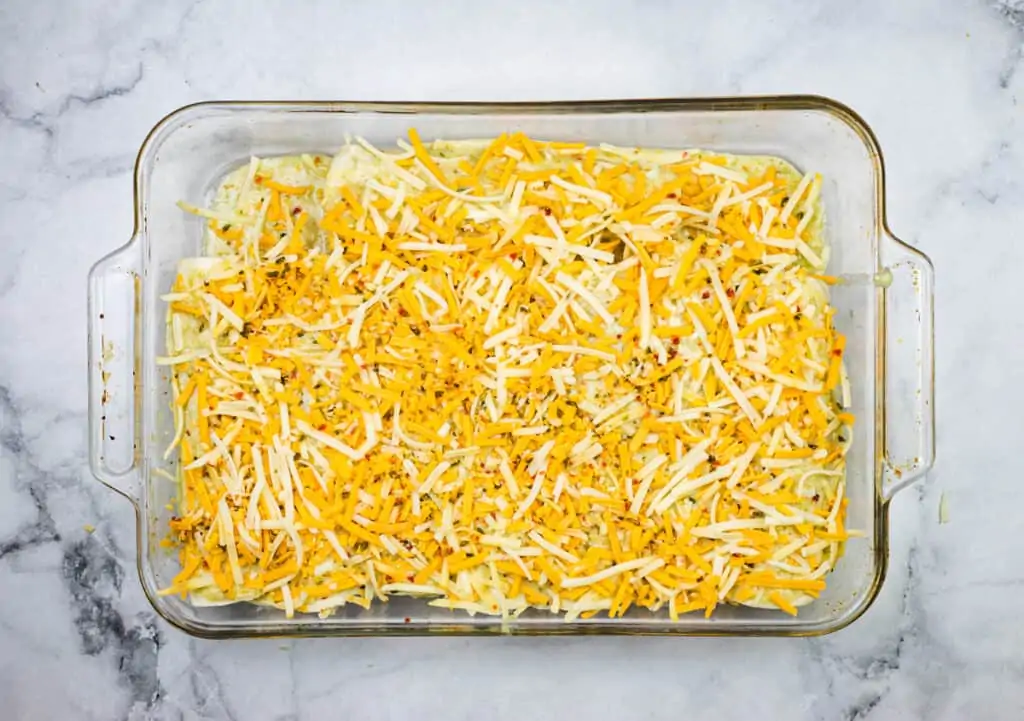 The casserole dish topped with cheese.