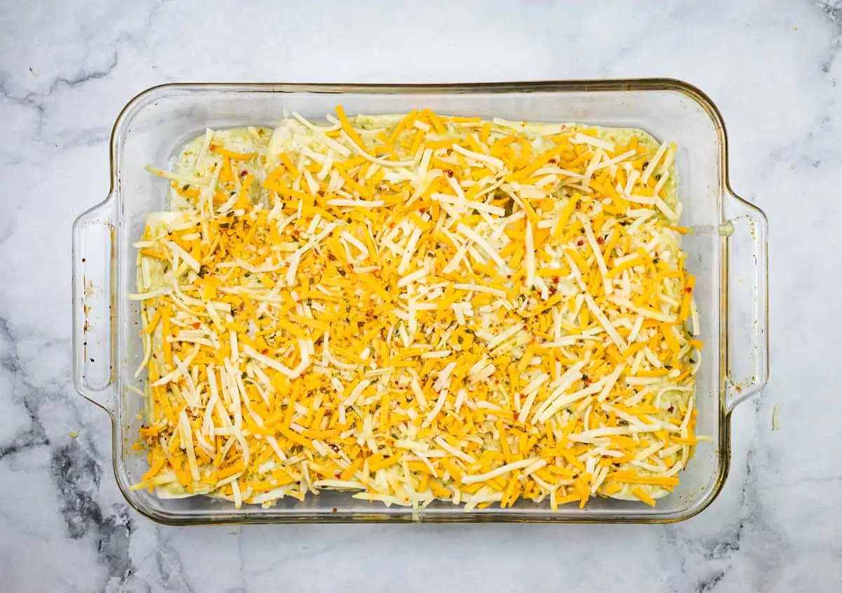 The casserole dish topped with cheese.