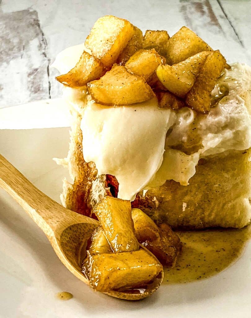 apple pie cinnamon rolls on a plate with a small spoon