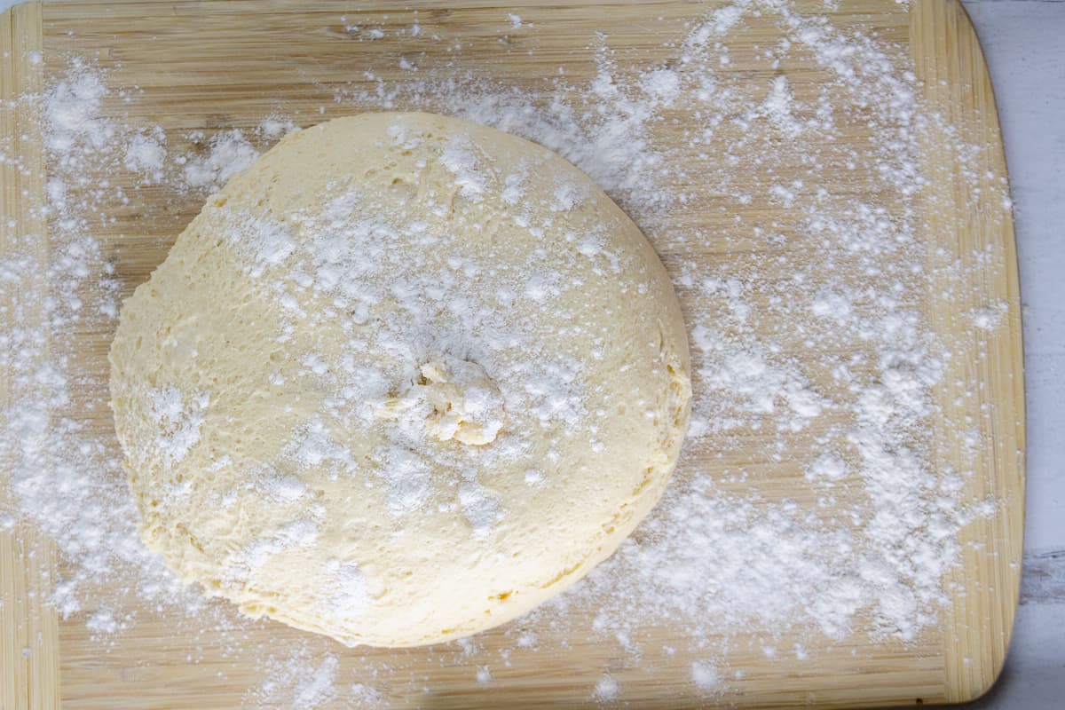 Roll the risen dough on a floured surface.