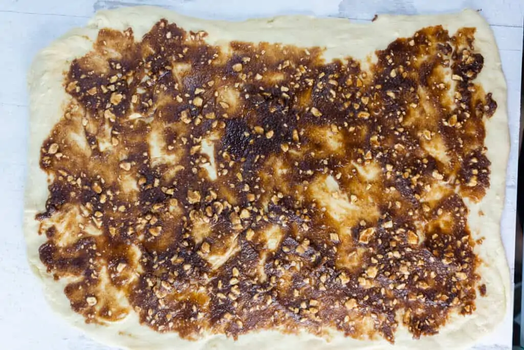Apple filling spread over the rolled dough.