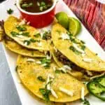 birria tacos on a white plate