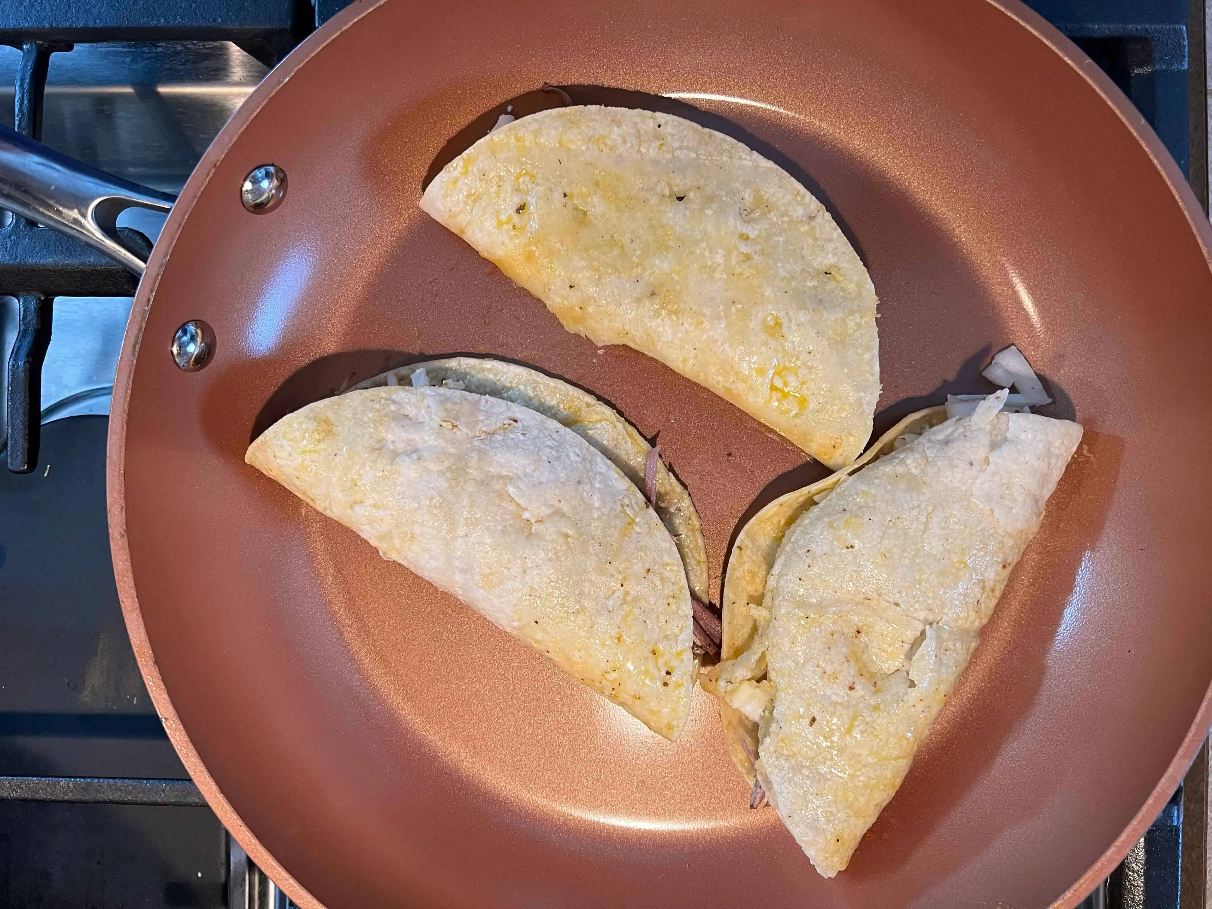 Fry the dipped and filled tortillas until golden brown.