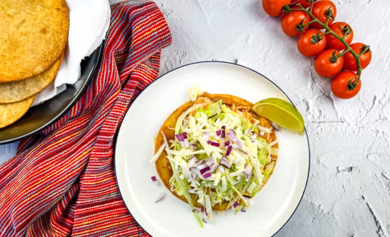 Chicken tinga tostadas on a plate.
