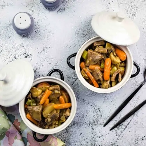 leftover roast beef stew in 2 serving dishes with spoons